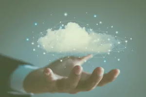 Decorative image of a hand holding a small cloud with the Cascadeo AI logo in white. 
